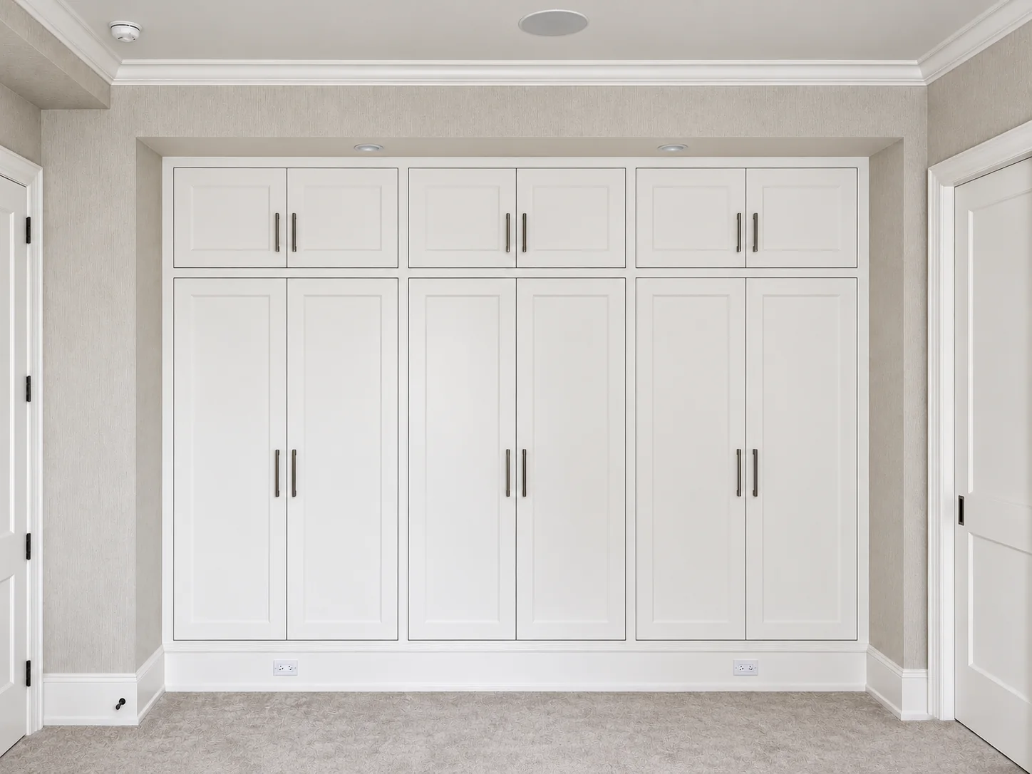 Full-height painted wardrobes with paneled doors on Central Park South