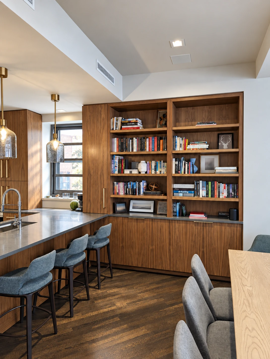 Built-in bookshelves beside the kitchen and dining area in the Flatiron District project