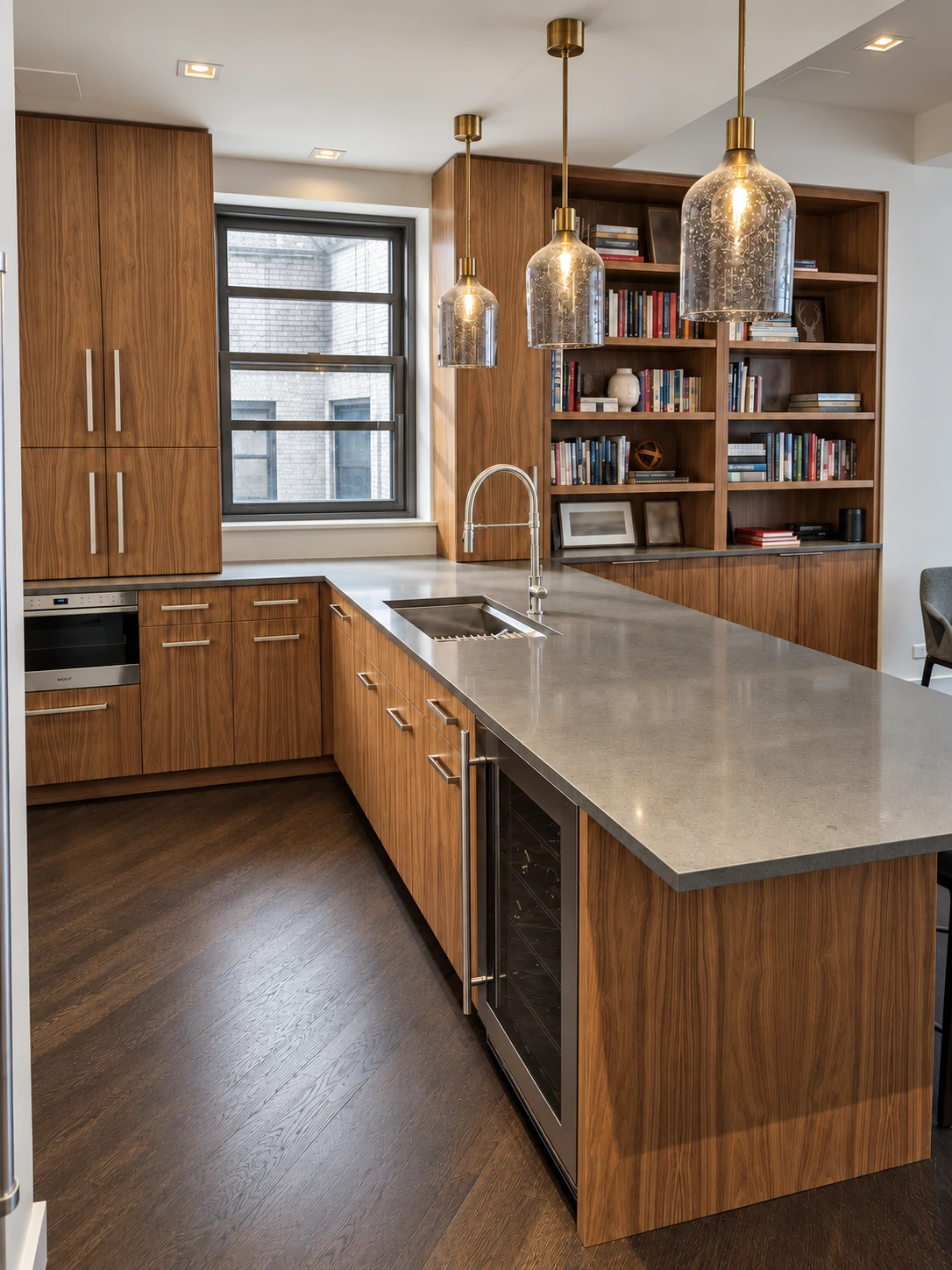 Flatiron District kitchen island and fitted wood library viewed across the sink and dining area