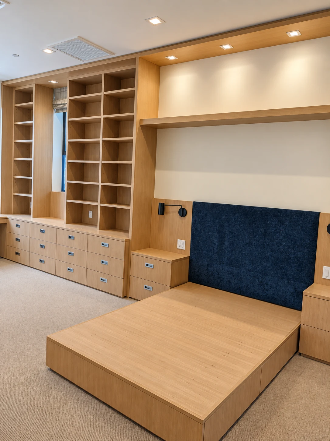 White oak bookcases and drawer cabinetry beside the integrated bed platform in a Hudson Square teen’s bedroom