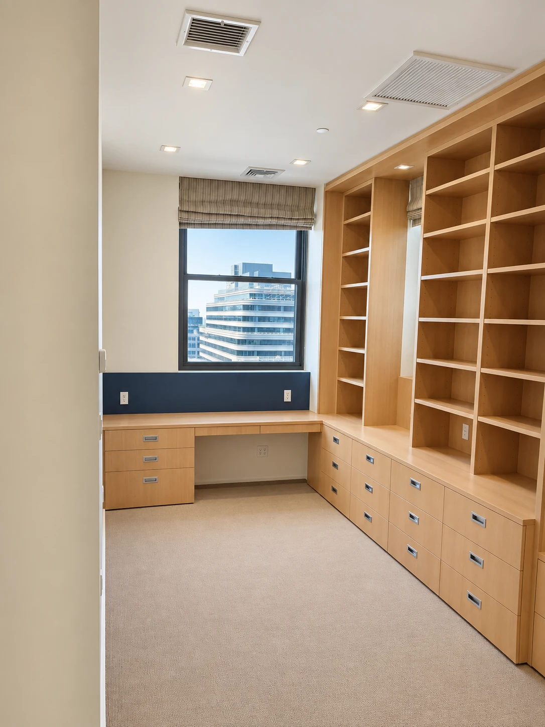 White oak study desk beneath the window, full-height bookcases and drawer storage in a Hudson Square teen’s bedroom