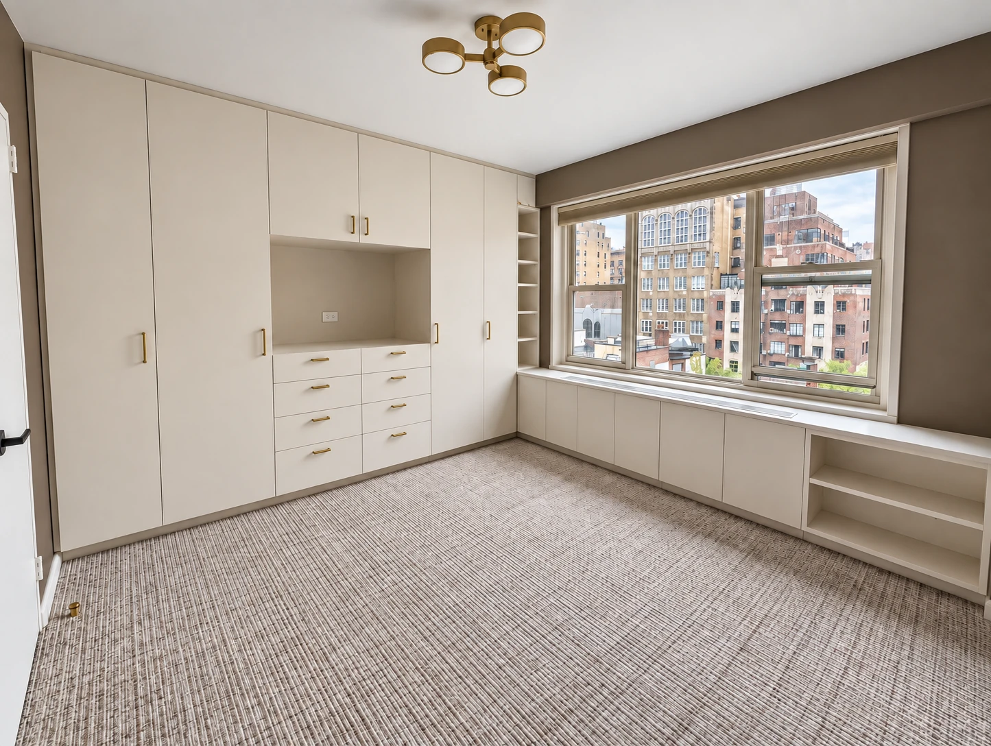 The Lenox Hill project: full-height painted cabinetry, drawers and storage below the windows