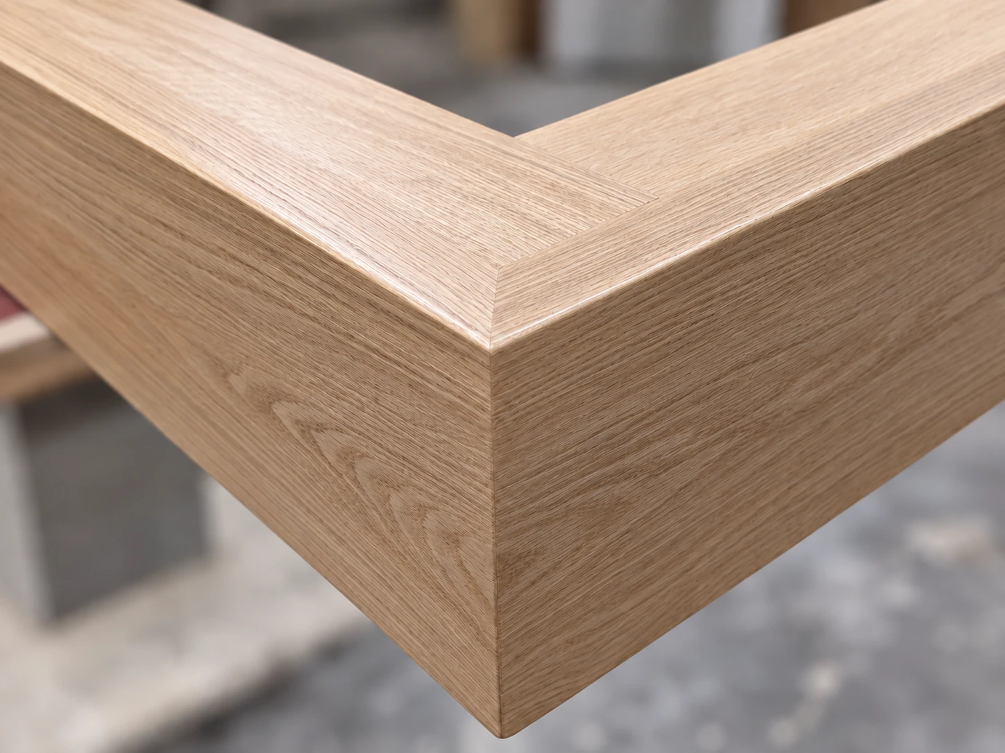 Close view of a wood-grain mitred corner during fabrication in the JQ workshop
