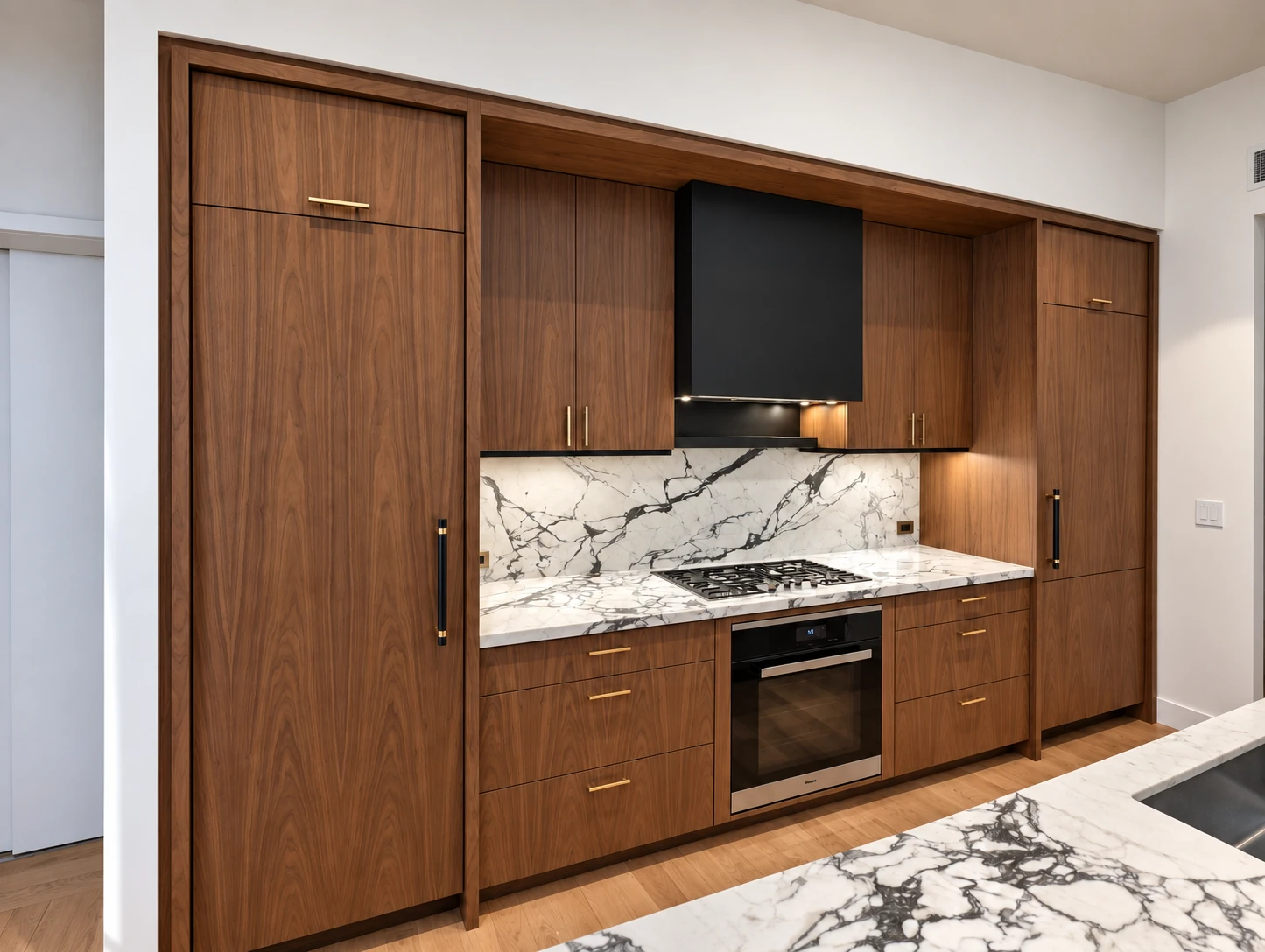 Full-height walnut veneer cabinetry and a recessed cooking area in SoHo