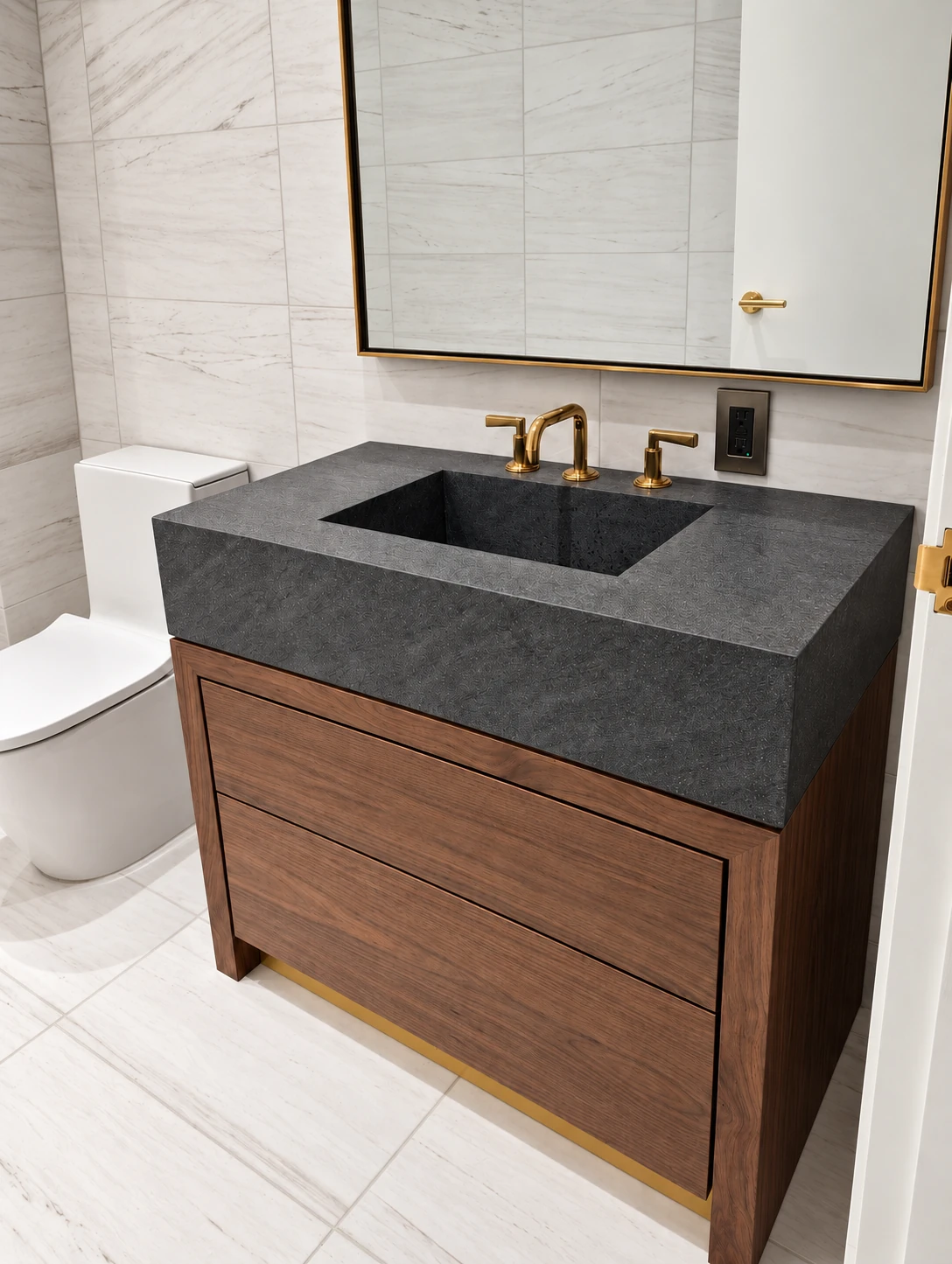 Wood bathroom vanity with a dark stone basin in SoHo